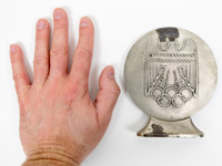 Groe Eisengumedaille  mit Inschrift "Im Jahr der Olympischen Spielen 1936". Versilbert, 11,7 cm auf einem Sockel.